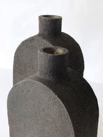 detail of black stoneware vase with black sand style clay texture